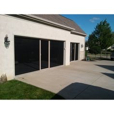 a garage with sliding glass doors on the outside