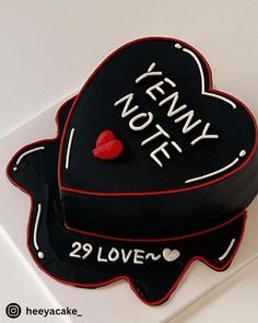 a black cake with white writing on it