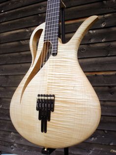 a close up of a wooden guitar with strings on it's back and neck