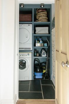 a washer and dryer sitting in a closet next to each other on the floor