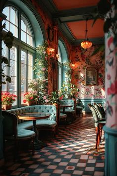 a room filled with lots of furniture and flowers on the wall next to large windows