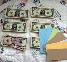 the money is laid out on top of each other with different colors and patterns to choose from