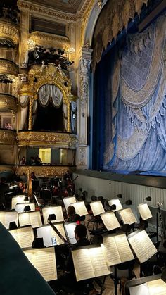 an orchestra with sheet music on the stage