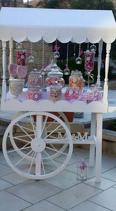 a white cart with candy and candies on it