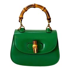 -Gucci Dyana Lux Calfskin Mini Bamboo 1947 Top Handle Bag  -Green calfskin leather -Bamboo handle -Two removable shoulder straps -Turnlock closure -Interior pocket   Authenticity: -Stamped Gucci on hardware and interior pocket   Dimensions: 6.75” L x 4.5” H x 3” D Chic Gucci Shoulder Bag With Bamboo Handle, Classic Gucci Bag With Bamboo Handle, Gucci Top Handle Shoulder Bag With Bamboo Handle, Classic Evening Shoulder Bag With Bamboo Handle, Gucci Satchel With Bamboo Handle, Gucci Bamboo Handle Rectangular Bag, Gucci Rectangular Bag With Bamboo Handle, Gucci Top Handle Evening Satchel, Green Gucci Bag With Detachable Handle