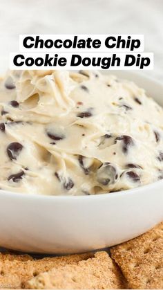 a white bowl filled with cream cheese and chocolate chip crackers on top of it