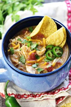 a blue bowl filled with chicken tortilla soup