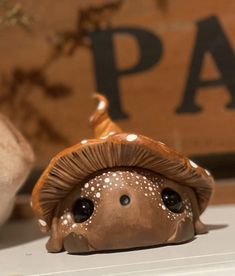 a mushroom figurine sitting on top of a shelf