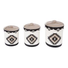 three canisters with black and white designs on them