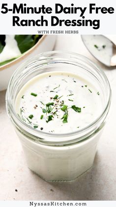 a glass jar filled with ranch dressing on top of a table