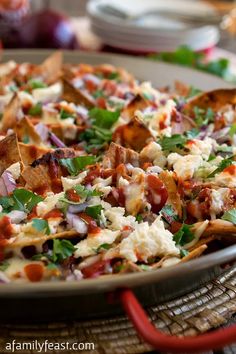 a plate full of nachos on a table