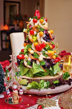 a christmas tree made out of lettuce, tomatoes, and other veggies