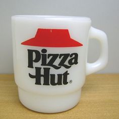 a white cup with a red lid and the word pizza hut on it