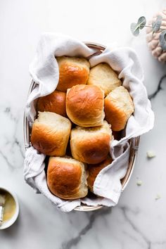 bread rolls in a basket on a marble table