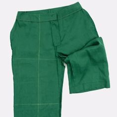 the green pants are lined up against the white background and there is no image on it