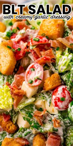 a salad with croutons, lettuce and tomatoes on it in a white bowl