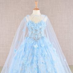 The Charming Dress Made Of Lightweight Mesh Has A Structural Top Decorated With Delicate Floral Appliques That Are Complemented By Sparkling Rhinestones And Beads. The Dress Designed For Formal Events Has A Thin Cape That Gives The Image Extravagance And Uniqueness. Your Little Princess Will Be The Most Elegant In This Gorgeous Dress! Fabric: Mesh Length: Tea Length Color: Baby Blue Neckline: Off Shoulder Silhouette: Ball Gown Sleeve: Sleeveless, Mesh Cloak Back: Lace Up Skirt: Layered Embellish Baby Blue Quince Dresses, Blue Dresses For Kids, Dream Quinceanera, Red Sparkly Dress, Nails Toes, Tea Length Prom Dress, Lace Up Back Dress, Off Shoulder Ball Gown, Blue Quince