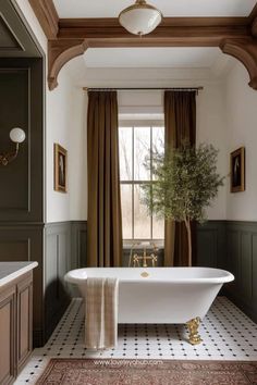 a white bath tub sitting under a window next to a rug on top of a floor