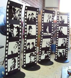 four black and white film strips with pictures of men on them in front of a brick wall