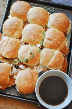 chicken sliders on a tray with dipping sauce