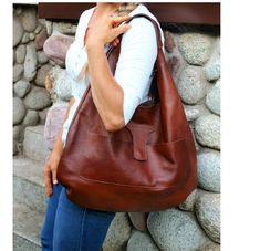 "Leather Tote Shoulder bag, Slouchy Tote purse, Handbag for Women, Soft Leather Bag, Every Day Bag, Women leather bag, leather hobo bag for woman, leather purse Cognac leather women's handbag made of high-quality grain leather.  The stylish, elegant and unique model of the Slouchy TOTE bag makes the bag perfect for every day, as a gift for her or as a Christmas gift. The bag is very roomy. can easily fit books, magazines, IPAD, A4 files, books, cosmetic bag. The bag is fastened with a magnet.  Has a half-round model, it is great to wear on the shoulder.  It suits any style.  There is a pocket on the front. Manufacturer: Poland Finish: 100% natural Italian full grain leather Titanium threads Extras: a front pocket with a magnetic closure On the shoulder: yes To hand: yes Over the shoulder: Soft Leather Hobo Bag, Slouchy Hobo Bag, Tote Bag With Pockets, Slouchy Tote, Leather Cosmetic Bag, Leather Tote Bag Women, Large Leather Bag, Leather Weekender Bag, Leather Weekender