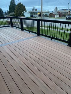 a wooden deck with black rails and railings