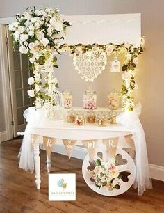 a white table topped with lots of flowers