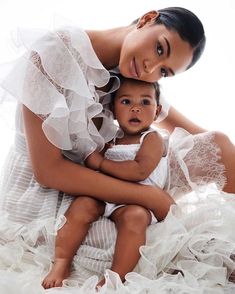 a woman holding a baby in her arms