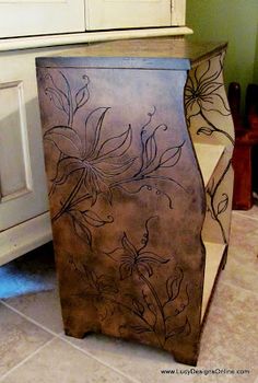 a brown cabinet sitting on top of a tiled floor