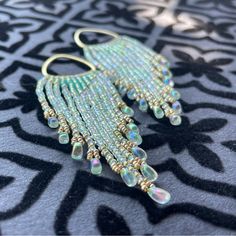 Artisan Boho Beaded Fringe Earrings Gold Lustered, Translucent Sea Glass Green With Subtle Aurora Borealis, Rainbow Effect Accented With Central, Milky Aqua Opal Triangle & Champagne Duracoat Miyuki Beads. Cascading Fringe Strands Ending In Sea Foam Lined, Crystal Drop Beads In Matching Ab Finish. Raw Brass Component Hardware. Choose Your Own Finishings/Clasp: Brass, 28k Gold Plate, Or 18k Gold Fill French Earwire, Closed, Or Open Ear Hook Brand New, One Of A Kind Precision Cut, High Color Resol Over The Ear Earrings, Aqua Beaded Earrings, Grunge Beaded Earrings, Bohemian Embellished Beaded Earrings, Green Handmade Beaded Earrings For Celebrations, Handmade Green Beaded Earrings For Celebration, Green Beaded Fringe Jewelry For Party, Green Beaded Earrings With Dangling Beads For Celebrations, Green Beaded Dangling Earrings For Celebration