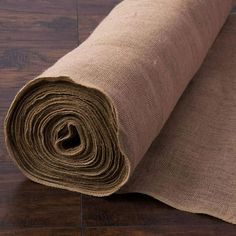 a roll of burlock on the floor next to a piece of brown fabric