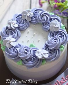 a cake decorated with purple icing and white flowers