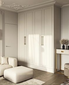 an elegant living room with white furniture and gold accents on the walls, along with beige carpeting