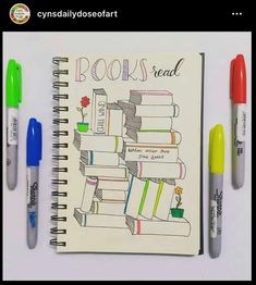 a notebook with books and markers on it