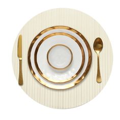 a white plate with gold trim on it and two silver spoons next to it