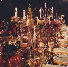 the table is set with candles and plates