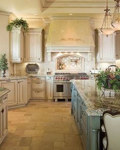 a large kitchen with marble counter tops and white cabinets