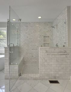 a large bathroom with a walk in shower next to a bathtub and sink area