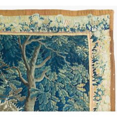 an image of a tapestry with trees and leaves on the bottom, in blue tones