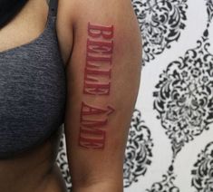 a woman with a tattoo on her arm that says, birth and end written in red ink