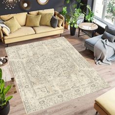 a living room filled with furniture and lots of pillows on top of a wooden floor