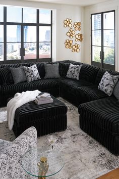 a living room filled with black and white furniture