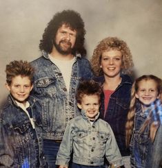 an old photo of a family with two children and one adult standing next to each other