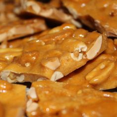 some kind of food that is on a plate with peanut butter and pecans in the background