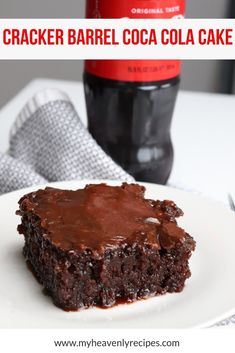 a close up of a piece of cake on a plate with a bottle of coke in the background