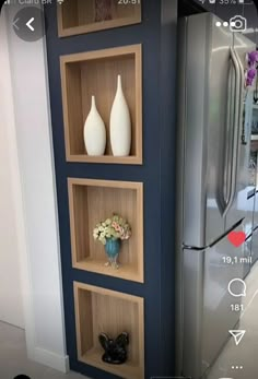 a refrigerator and some shelves with vases on them