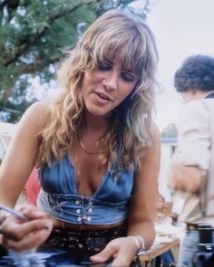 a woman sitting at a table with food in front of her