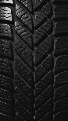 close up view of the tread pattern on a car's tire in black and white