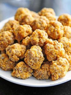 a white plate topped with meatballs on top of a table