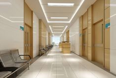 an empty hospital hallway with chairs and desks on either side of the corridor wall